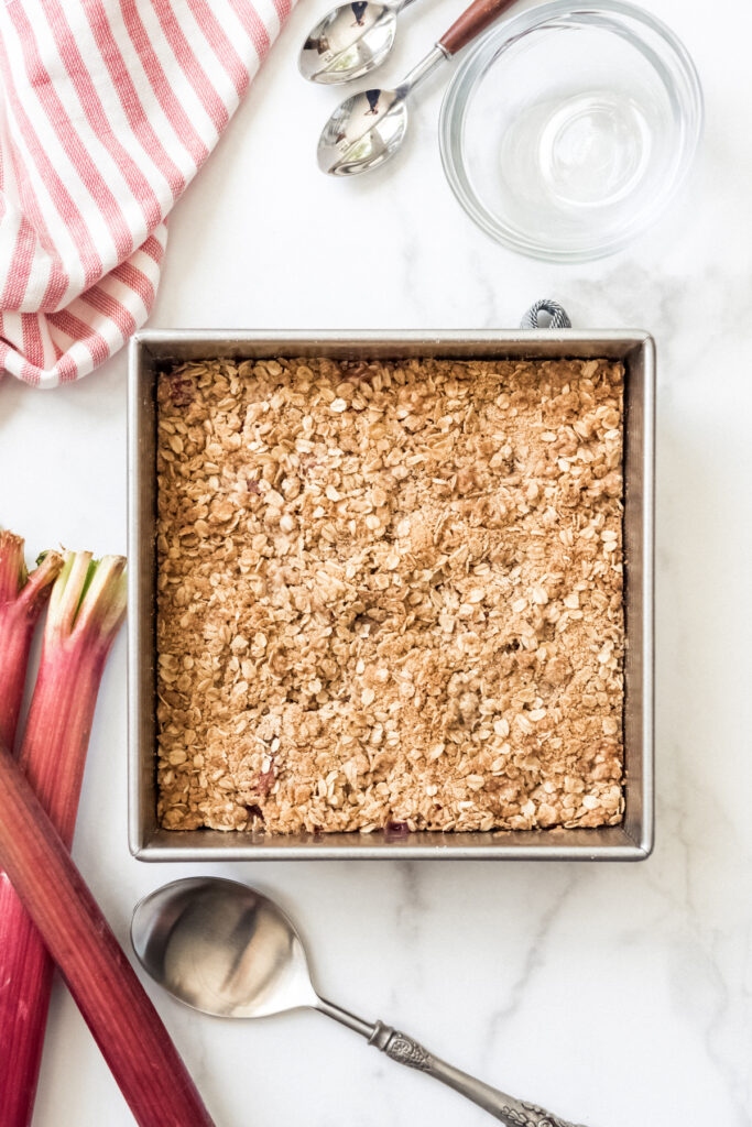 A square baking dish filled with rhubarb crisp.