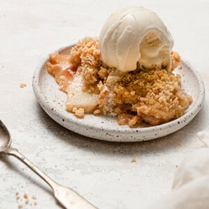 apple crisp on white plate with ice cream
