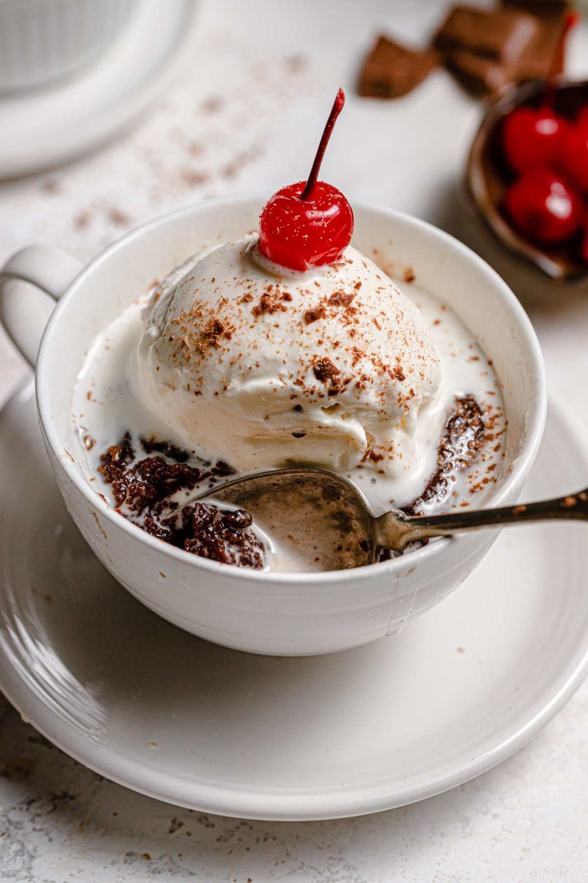 baked mug cake with ice cream and cherry