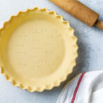 unbaked pie crust with scalloped edges in a pie plate