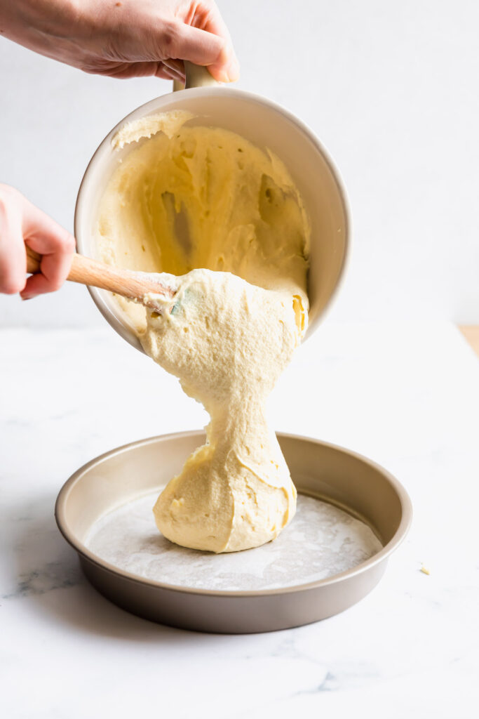 pouring vanilla cake batter into pan