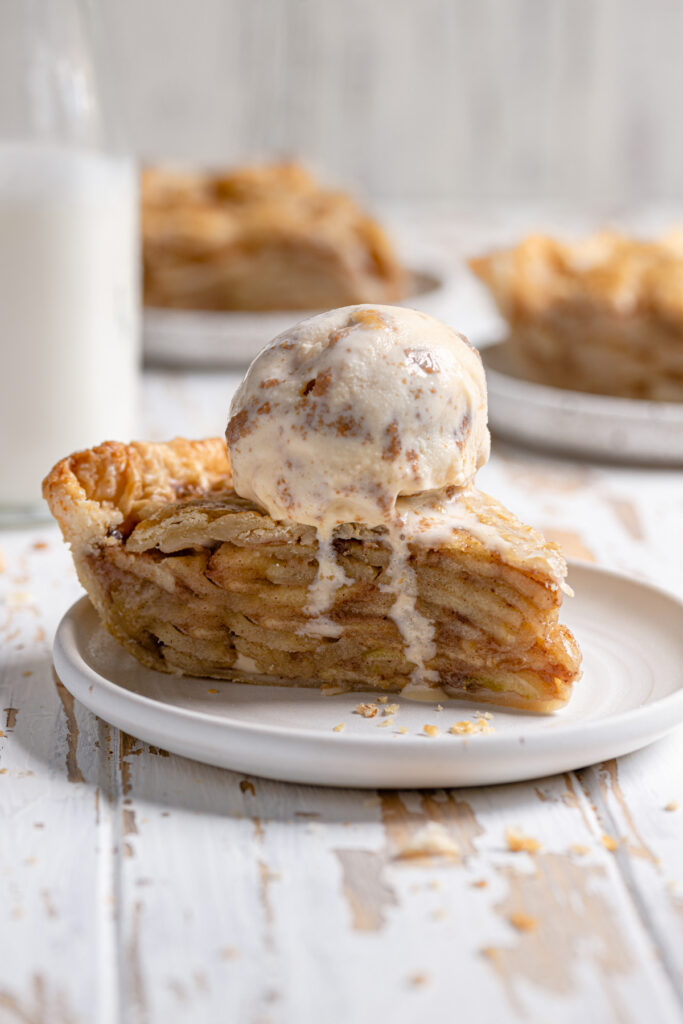 slice of apple pie with melting ice cream on top