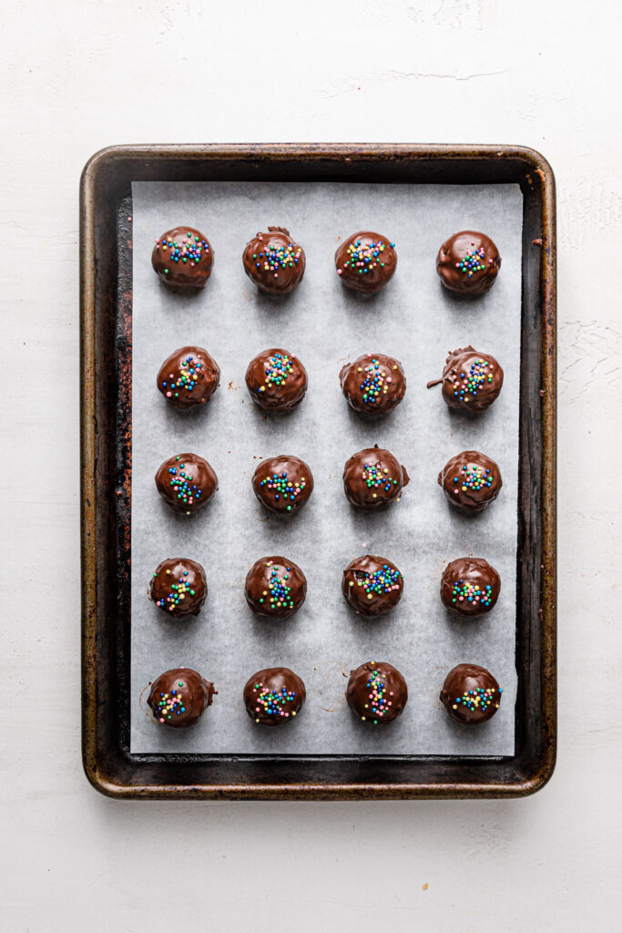 finished oreo balls on baking sheet with sprinkles