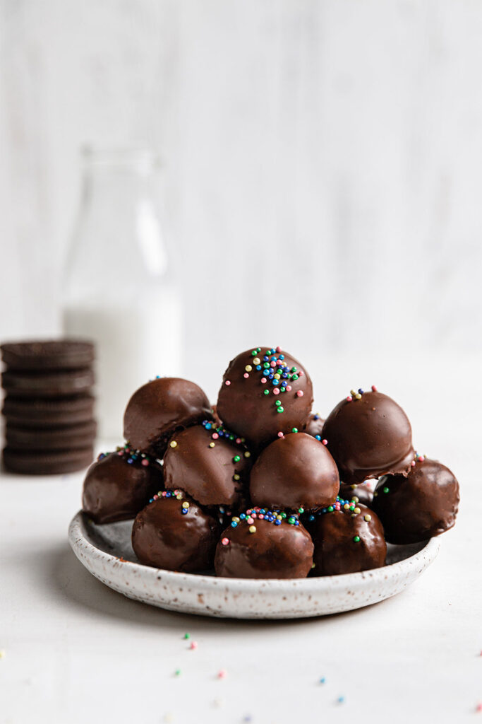 chocolate covered oreo balls on white plate