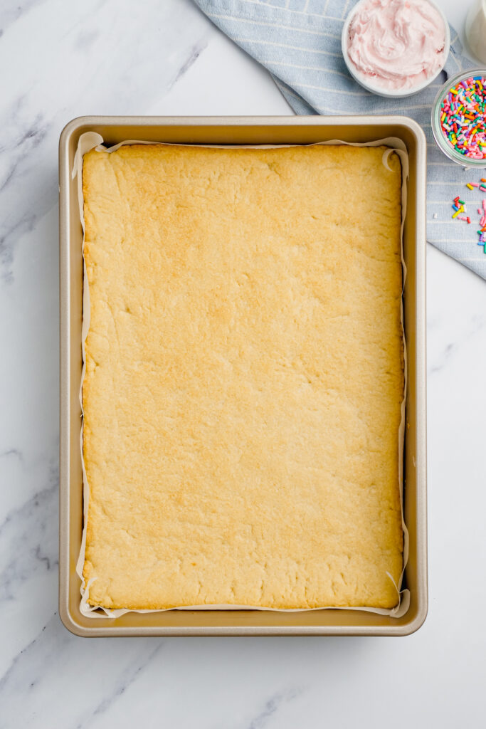 flattened sugar cookie dough in baking pan