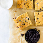 chocolate chip cookie bars on brown parchment paper