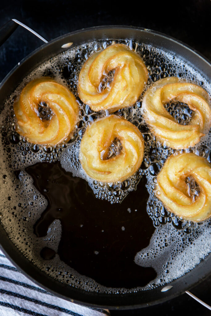 frying cruller donuts
