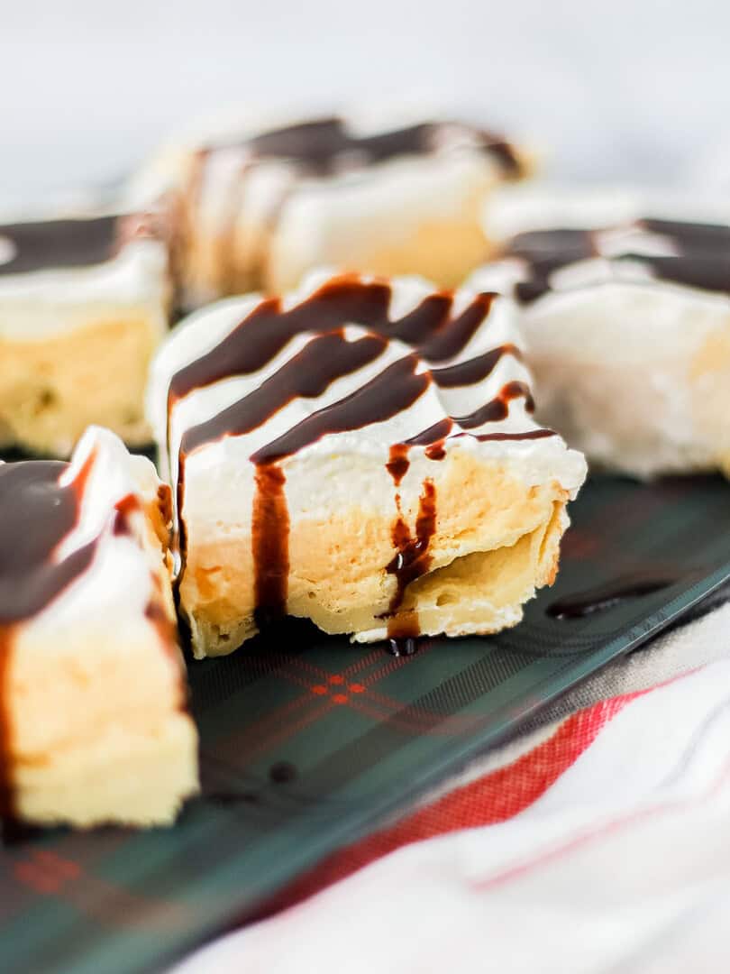 side view of slice of eggnog eclair cake