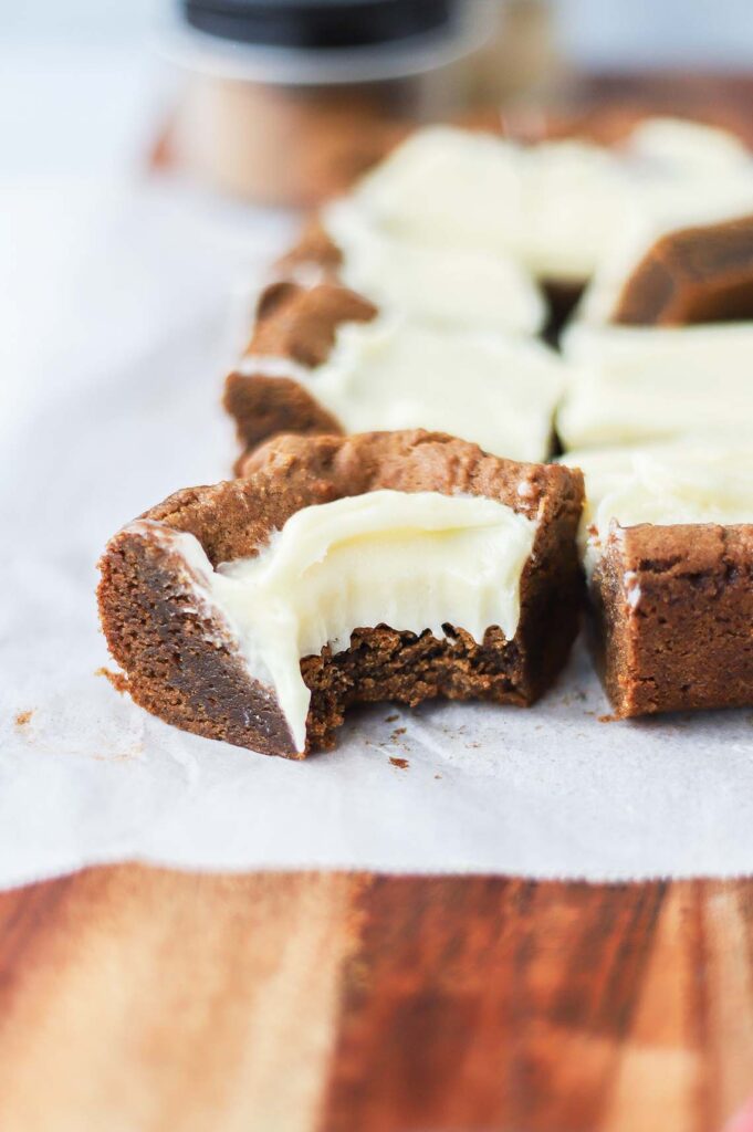 Side view of gingerbread bar with a bite taken out of it.