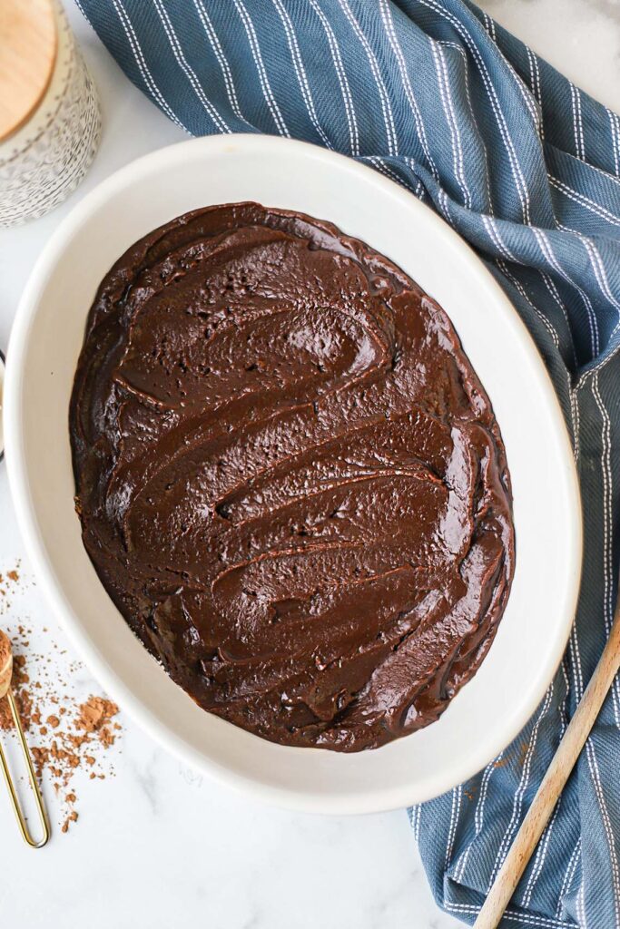 Overhead photo of chocolate cobbler batter in casserole dish