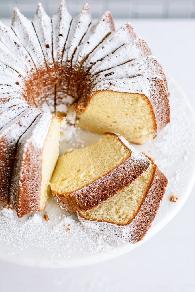 vanilla bundt cake with slices taken out of it