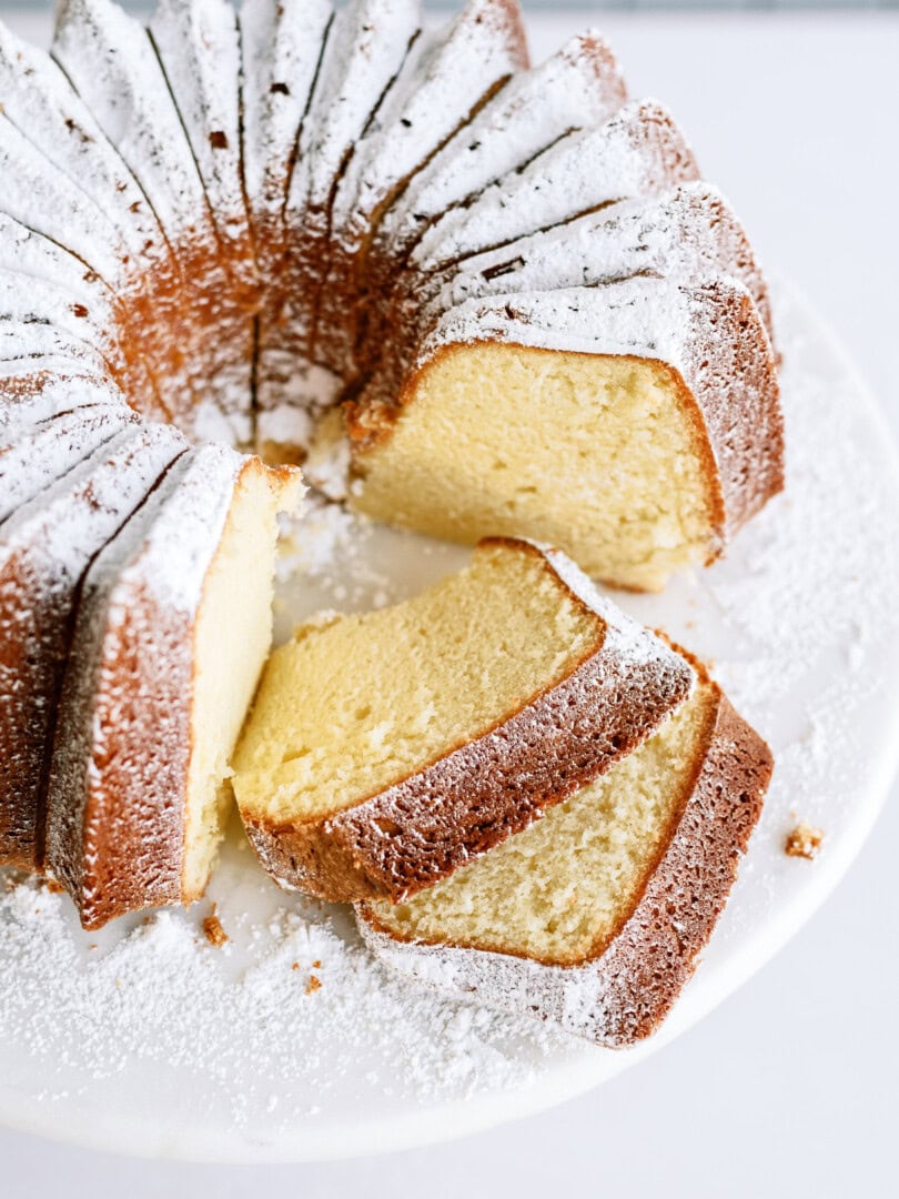 vanilla bundt cake with slices taken out of it