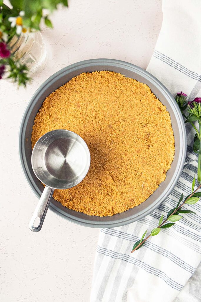 pressing graham cracker crust into pan