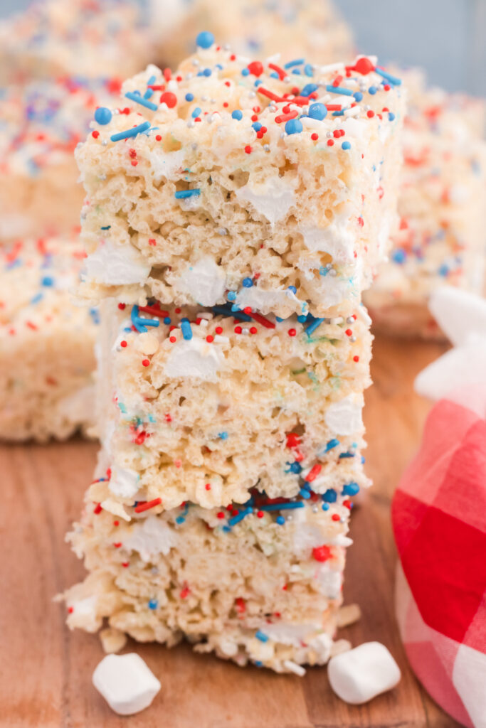 A stack of white rice krispie treats with sprinkles.