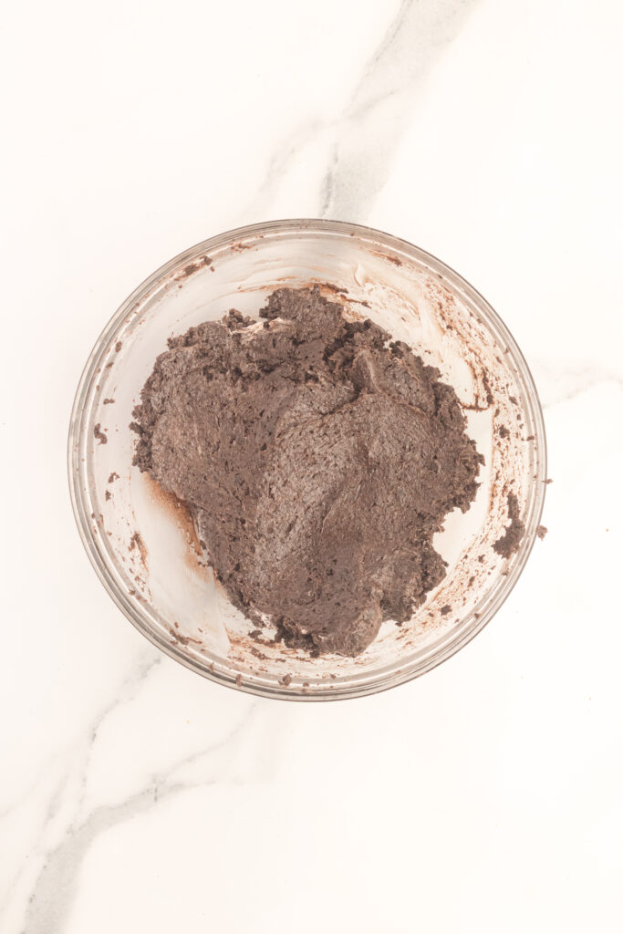 a bowl of crushed oreos and cream cheese